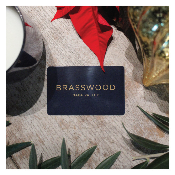 An image of a blue Brasswood gift card for Brasswood Estate, with gold text that reads, "Brasswood - Napa Valley".