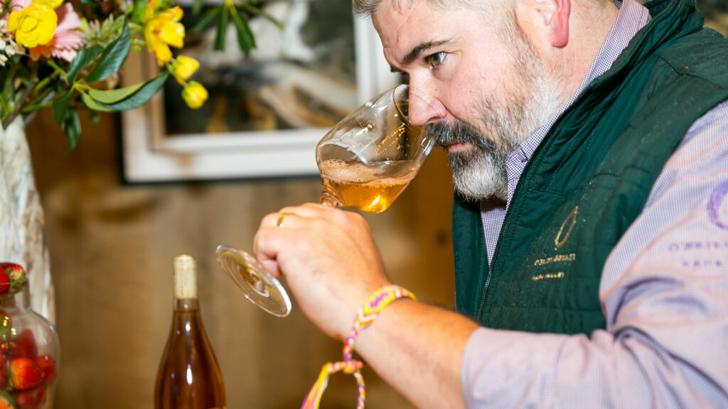 A photo of a gentleman tasting wine at Brasswood's BudBreak event.